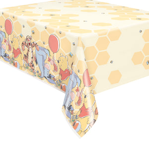 corner view of plastic tablecover with winnie the pooh and friends on honeycomb background 54 inches by 84 inches