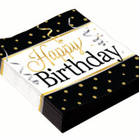 happy birthday luncheon napkins black background with gold dots and streamers with confetti
